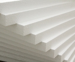 Close-up view of stacked pile of expanded polystyrene insulation sheets.