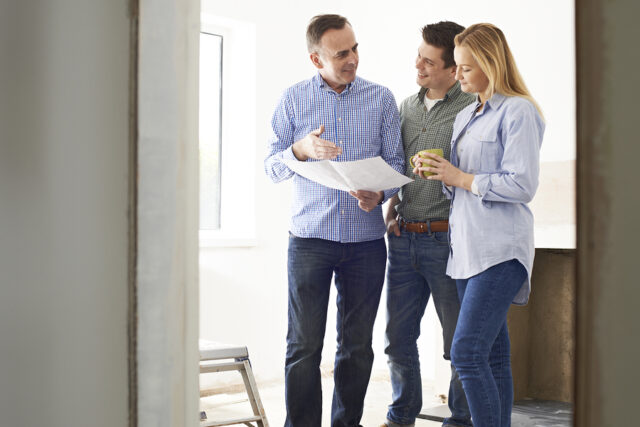 Homeowners talking with a contractor.