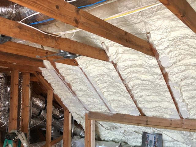 Spray foam insulation in an angled interior wall.