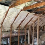 Spray foam insulation in an angled interior wall and ceiling.