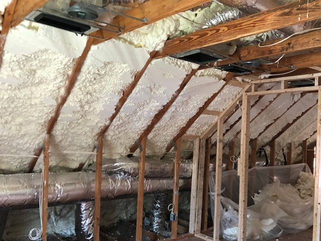 Spray foam insulation in an angled interior wall and ceiling.