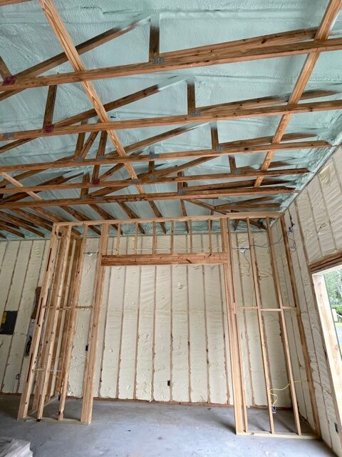 Interior commercial structure with spray foam on walls and ceiling.