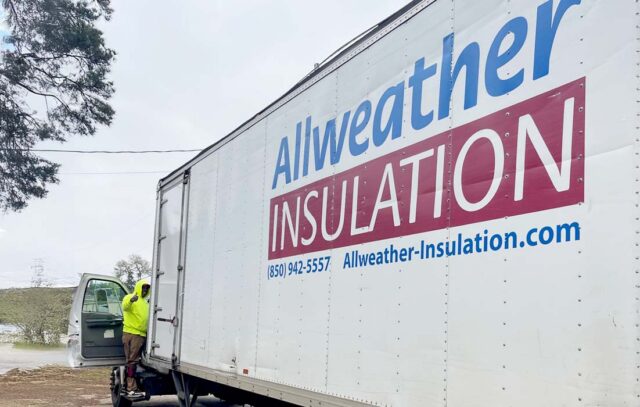 Allweather Insulation truck with company logo and contact information, worker in hi-vis jacket entering truck